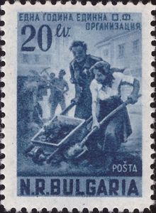 Man and woman with wheelbarrow and spade