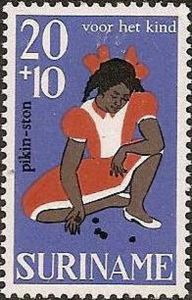 Girl playing dibs (five stones)