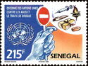 U.N. Emblem and Hand Holding up Stop Sign to Drugs