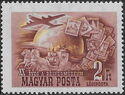 Aircraft, mail coach and stamps in front of globe