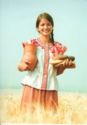 Girl in the field carrying bread