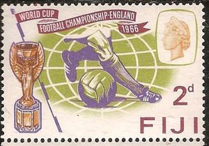 Footballer's legs, ball and Jules Rimet Cup