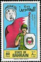 Soldier in front of flag, coat of arms of Bahrain