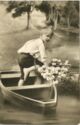 Little boy with a flower in the boat