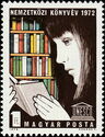 Reading girl in front of bookshelf, UNESCO emblem