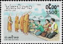 People giving food to monks