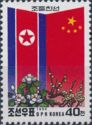 National flags of North Korea and China, magnolia and plum …