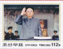 Kim, with military officers, hand raised