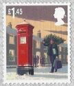 Man carrying Christmas Tree past Post Box