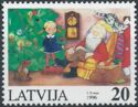 Girl at Tree and Father Christmas in Armchair