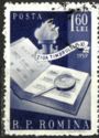 Stamp Day: Stamp album, magnifier, torch with inscription